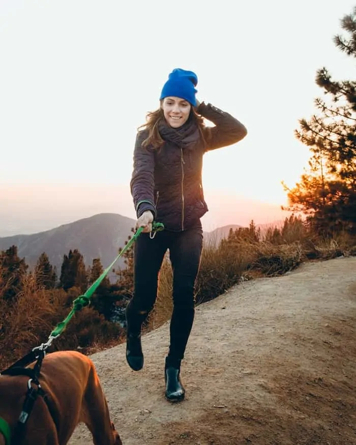 Pic 1 a dog pulling a woman on a walk