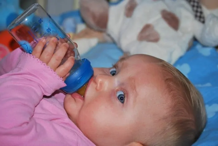 2 baby drinking bottle of pedialyte