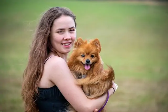 7. girl with pomeranian hearing dog