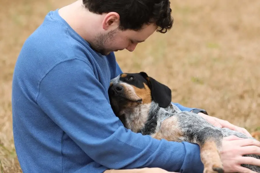 8 a man cuddling his dog