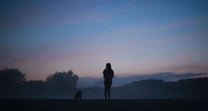 6 a woman and her dog in twilight